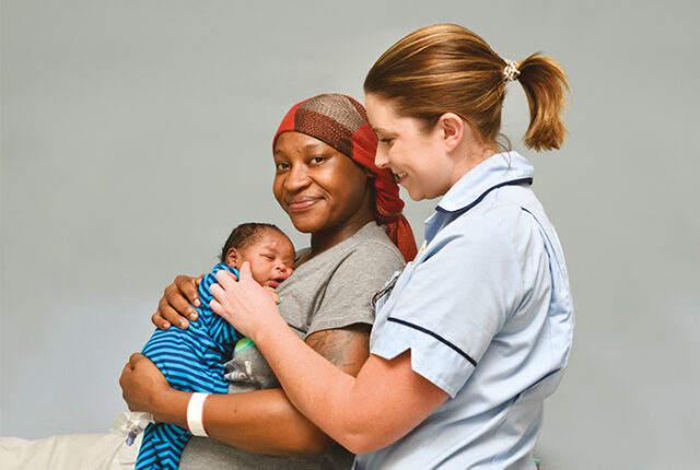 Nurse helping mother holding their baby
