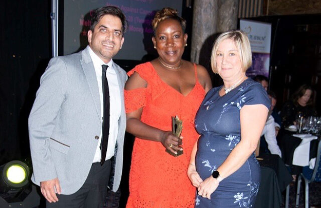 Image of Hope Against Cancer staff members collecting the Voluntary Action Leicestershire 'County Charity of the Year' award.